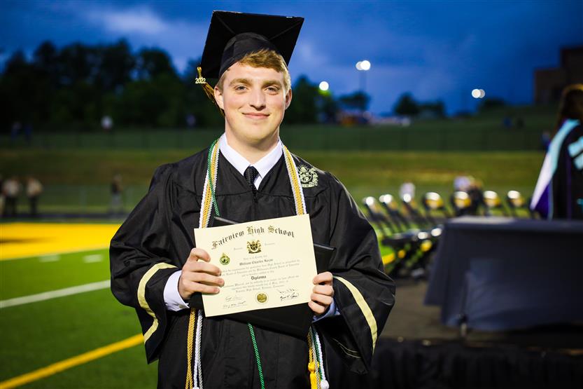 Students graduate on a football field